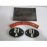 Two alloy locomotive shed code plates, along with a brass "Flying Scotsman" name plate and a limited