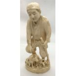 A signed 19th Century Okimono of a man with a dog - repaired