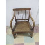 An antique mahogany country carver chair with elm seat