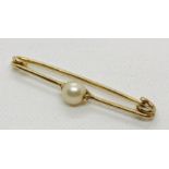 An unmarked gold brooch set with a pearl. Total weight 2.9g