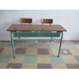 A mid century French school desk with two integral chairs