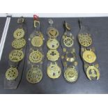 A collection of seventeen antique and other horse brasses on five leather straps
