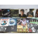 A collection of 12" vinyl records including David Bowie, Jefferson Starship, Elton John, Rod