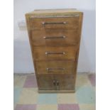 An art deco chest of four drawers with cupboard under