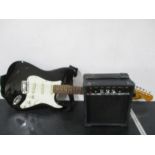 An Encore "Stratocaster" with tremelo along with a 10W Amp