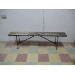 A vintage wooden bench with metal legs