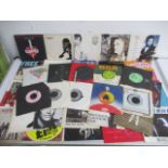 A collection of 7" vinyl single records including David Bowie, Free, Rainbow, The Rolling Stones,