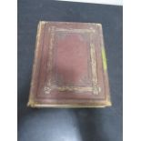 A Victorian leather-bound photo album with card cut outs