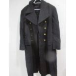 A Naval Commanders great coat with brass buttons and epaulettes