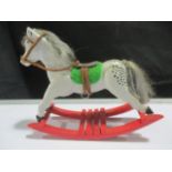 An antique style dolls house rocking horse