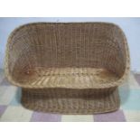 A wicker two seater settee