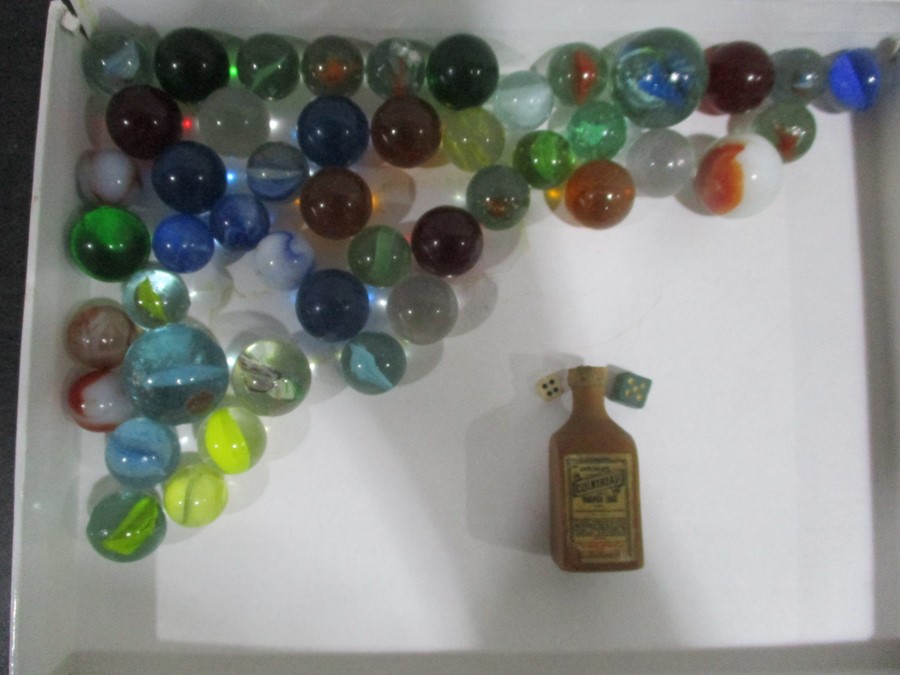 A small quantity of vintage marbles along with a wooden Cointreau bottle containing two miniature