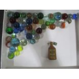 A small quantity of vintage marbles along with a wooden Cointreau bottle containing two miniature