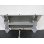 A grey painted shelf unit