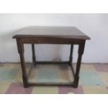 An antique oak/elm table with later top