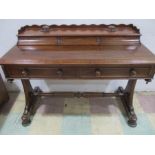 A Victorian desk with integral inkwells