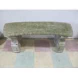A concrete curved garden seat on two supports