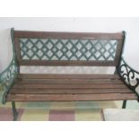 A garden bench with cast iron ends and back