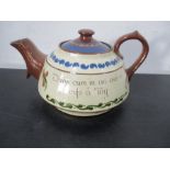 An oversized 6 pint Torquay ware teapot with motto, 13.75 inches x 7 inches