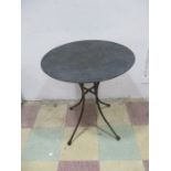 A metal circular garden table