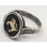 A continental silver gentleman's ring with a 14ct gold rearing horse motif