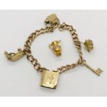 A 9ct gold charm bracelet with four 9ct gold charms and an 18ct gold charm( Weight 9ct .. 23g /