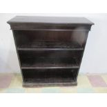 A dark stained freestanding bookcase