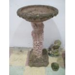 A birdbath along with a large terracotta pot on a stand and ornaments. etc.