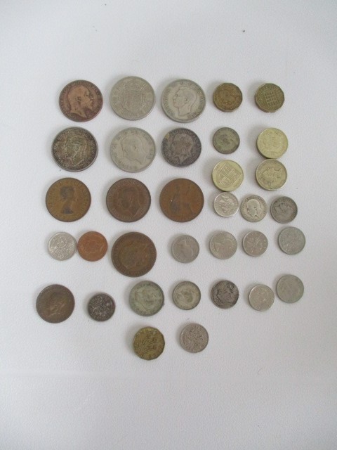 A small collection of various coins including silver