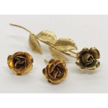 A 9ct gold brooch in the form of a rose stem along with a pair of similar gold coloured earrings (