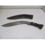 A Kukri knife, the blade stamped C I, G,1916 and 43, in leather scabbard