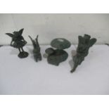 A collection of three resin figures in the form of fairies, along with a toadstool.
