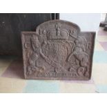 A cast iron fire back with coat of arms decoration