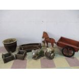 A collection of garden ornaments including two pigs, planters, hanging baskets etc