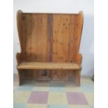 A vintage pine settle with panelled back