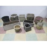 A collection of concrete garden planters, pots etc.