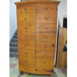 A large Mexican pine bow fronted wardrobe with four drawers under