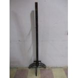 A vintage wood and cast iron shop display stand for Ewbank carpet sweepers