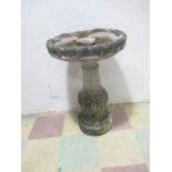 A weathered concrete bird bath - height 76cm