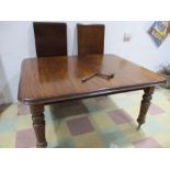 A Victorian mahogany wind out dining table with two leaves- winder in office