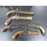 A collection of five replica flintlock pistols