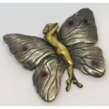 An Art Nouveau style SCM brooch in the form of a butterfly, the body formed as a nude lady in brass,