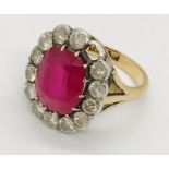 A ruby and diamond cluster ring ( 1 diamond missing), the central ruby measures approx. 12mm x
