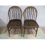 A pair of Ercol stick back dining chairs