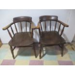 A pair of elm captain's chairs