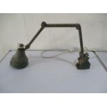 A vintage industrial wall mounted green anglepoise lamp