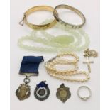 A collection of silver medallions, jade necklace, rolled gold bracelet, pearl necklace with 925