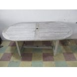 A wooden teak garden table