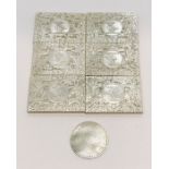 Six mother of pearl gaming counters with armorial decoration along with one other
