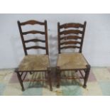 Two oak ladder chairs with rush seats